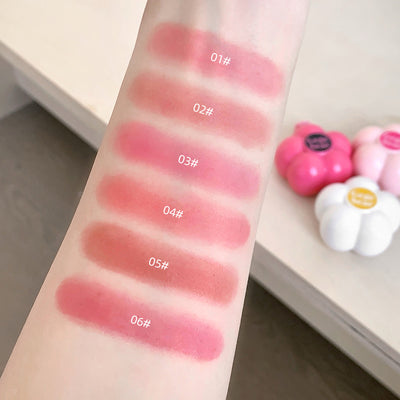 Lipstick swatches on a arm with labeled colors against a neutral background