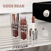 Lipstick and lip gloss set with a mirror on a reflective surface, featuring the brand 'GEGE BEAR'.
