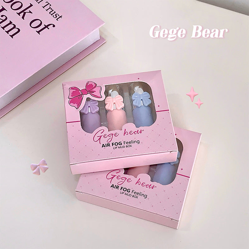 Pink packaging of Gege Bear lip mud box with three small bottles on a light pink background.