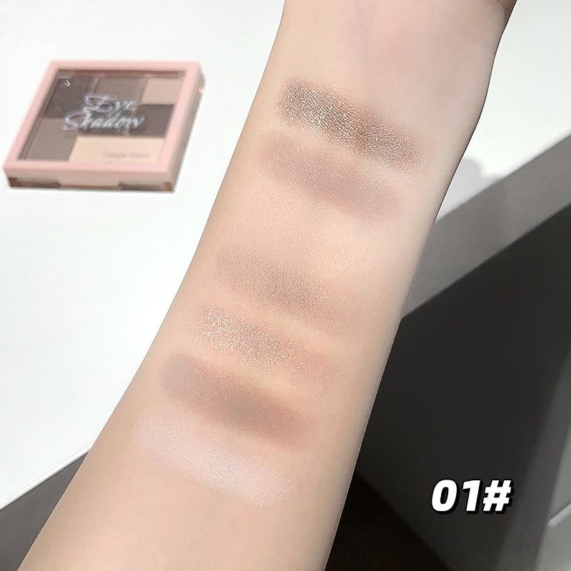 Eyeshadow swatches on a person's arm with a compact palette labeled '01#'.