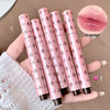 Pink lip gloss tubes with decorative patterns held by a hand, close-up of lip color shown.