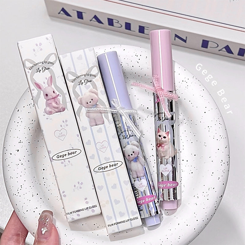 Lip gloss set with packaging on a white plate, featuring cartoon characters.