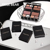 Makeup products with 'GEGE BEAR' branding on a reflective surface.