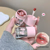 Pink lip balm with a small mirror held by a hand, with a close-up of lips and brand name 'Geege Bear' visible.