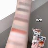 Makeup palette with swatches on a arm and a hand holding the palette.