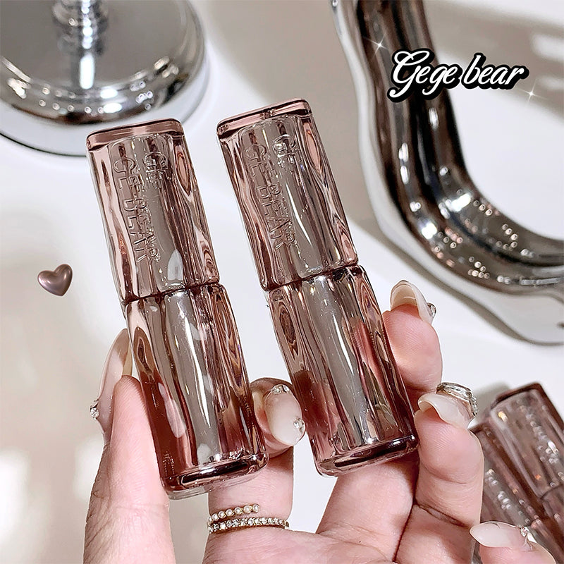 Three rose gold nail polish bottles held by a hand with a blurred background