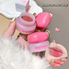 Pink lip balm and container held by a hand with a soft focus background