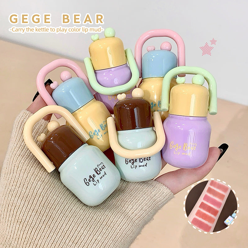 Colorful lip mud products with 'GEGE BEAR' branding on a beige surface.