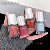 Four GEGE BEAR nail polishes held in a hand with a blurred background
