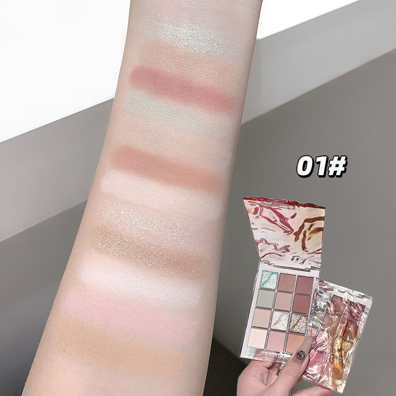 Makeup palette with swatches on an arm and packaging held by a hand.