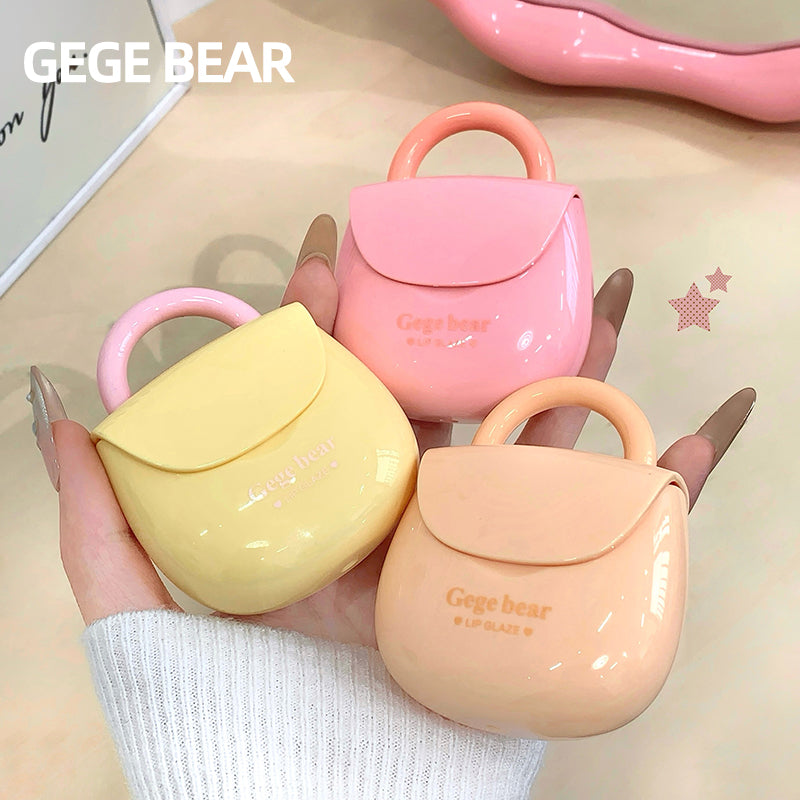 Three small, pastel-colored bags with 'GEGE BEAR' branding held by a hand.