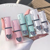 Set of Gege Bear lip glosses with heart-shaped designs on a white surface.
