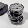 Clear plastic grinder with visible branding on a white background