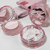 Pink cosmetic products with white cream on a light background