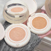 Three open compact face powders with visible color swatches on a textured surface.