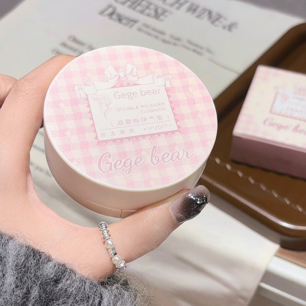 Round pink compact with 'Gege bear' branding held by a hand.