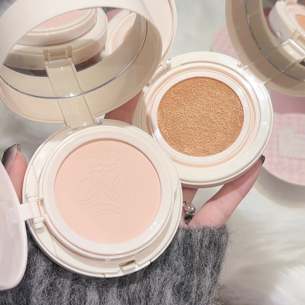 Two makeup compacts with different shades of powder, held by a hand.