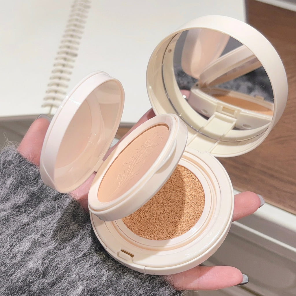 Compact powder in a round case held by a hand with a blurred background
