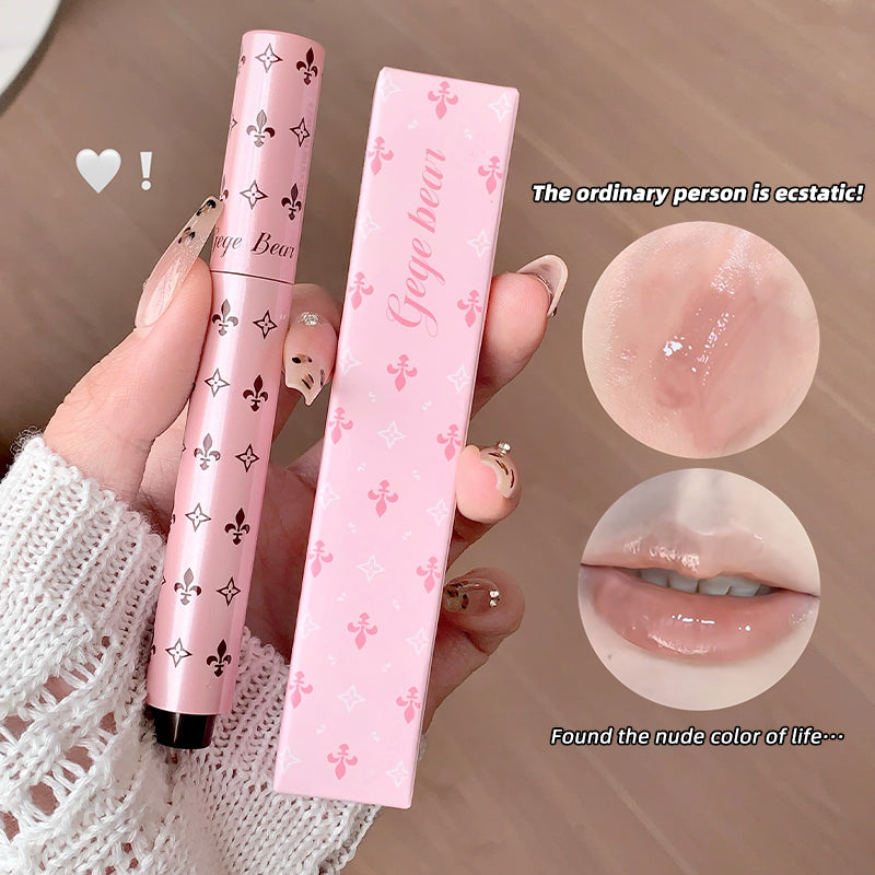 Pink lip product with packaging held by a hand, showing close-up of product on skin and lips.
