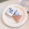 Makeup product with 'Gege Bear' packaging on a white plate