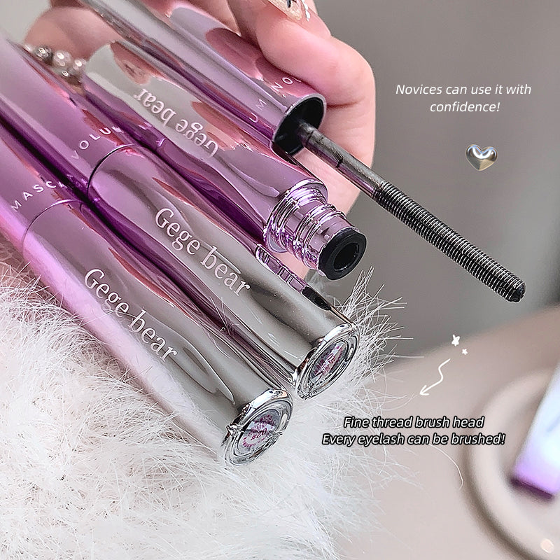 Pink mascara with 'Gege bear' branding held by a hand, on a soft white background.