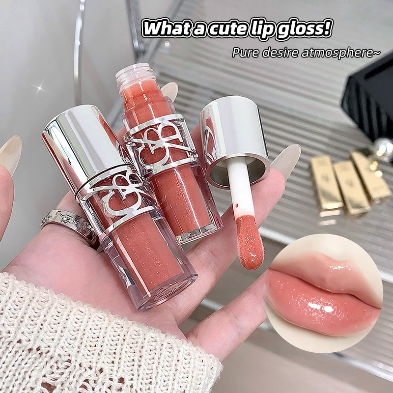 Lip gloss with silver cap held in hand, close-up of lip with gloss applied.