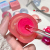 Pink jelly paste in a container with a spoon, surrounded by colorful blocks.
