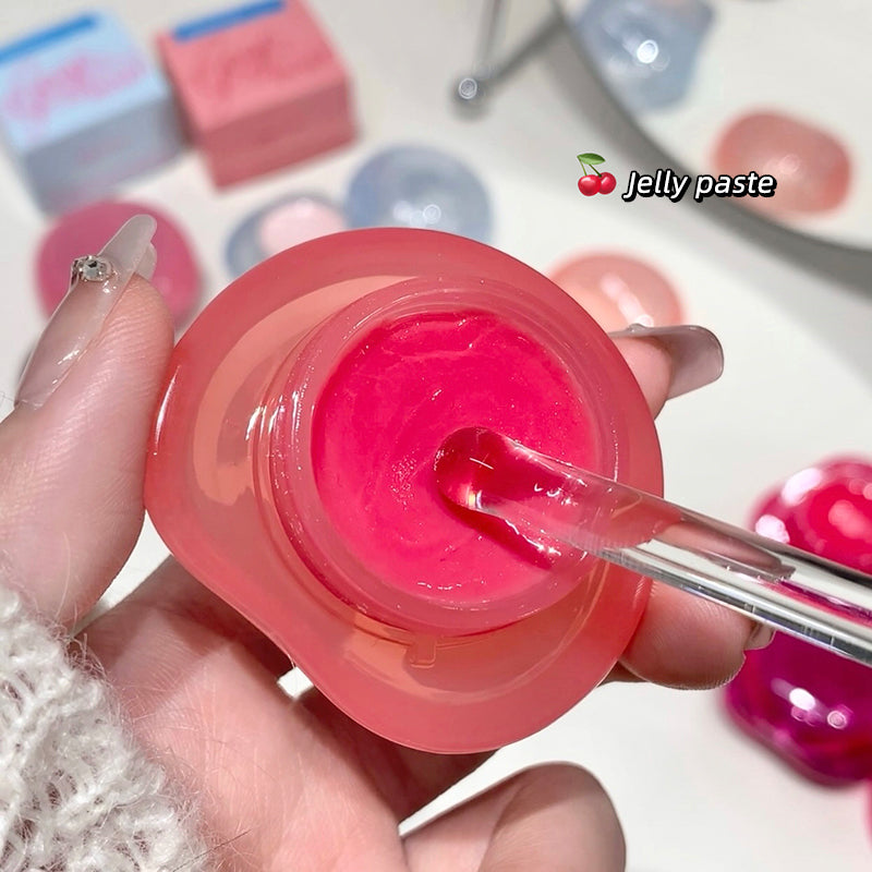 Pink jelly paste in a container with a spoon, surrounded by colorful blocks.