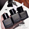 Four black Gege Bear perfume bottles held in a hand with a blurred background.