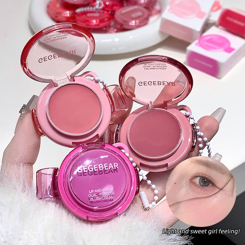 Pink blush compact with 'CEGBEARS' branding held by a hand, with blurred background.