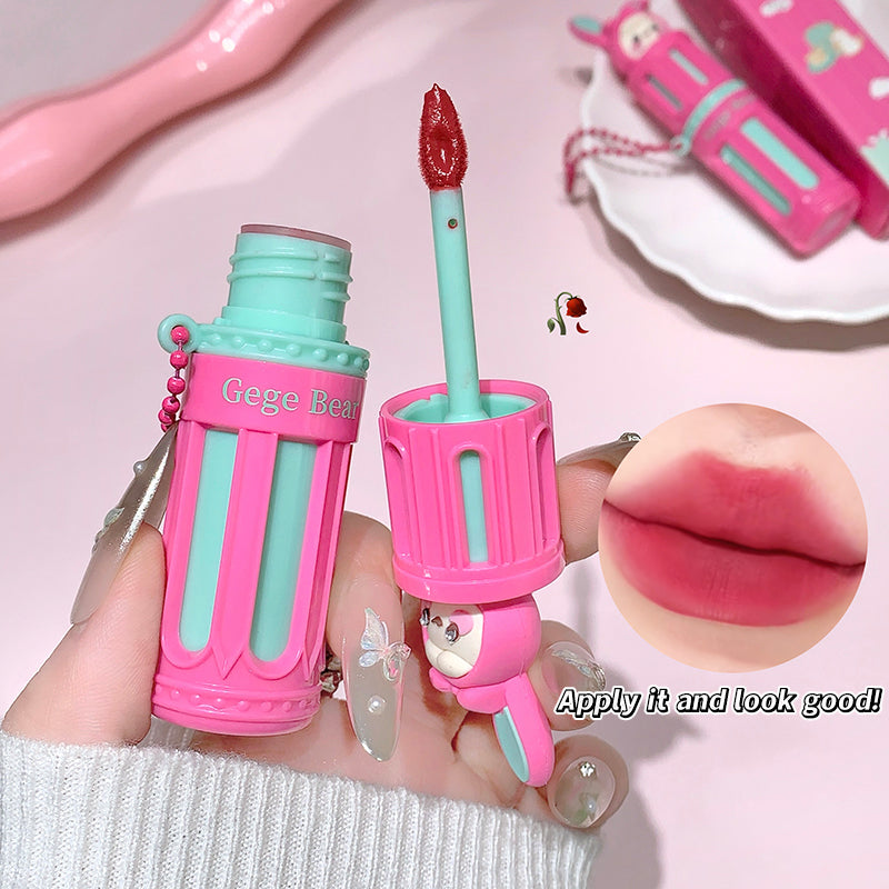 Pink and green lip gloss with a cartoon character on a pink background