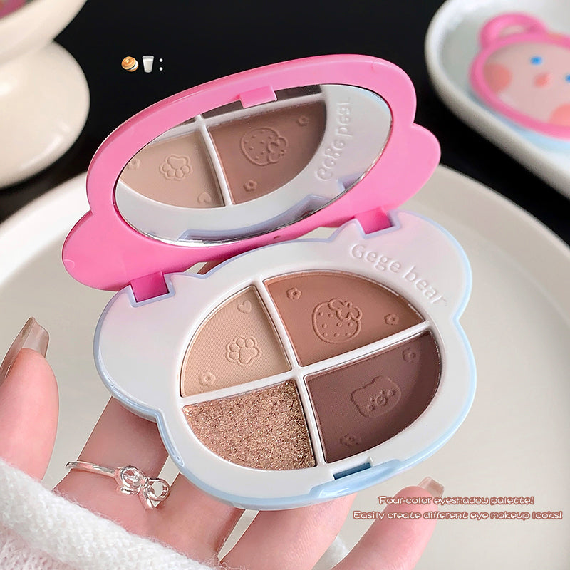 Makeup palette with pink and white design held by a hand