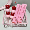 Pink and red bear-shaped lip masks with packaging labeled 'Gege bear' on a pink tray.