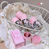 Pink and clear tumbler with lid and box on a white decorative background