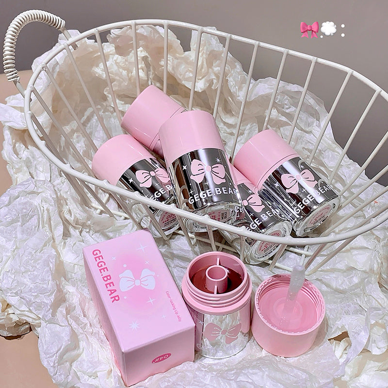 Pink and clear tumbler with lid and box on a white decorative background