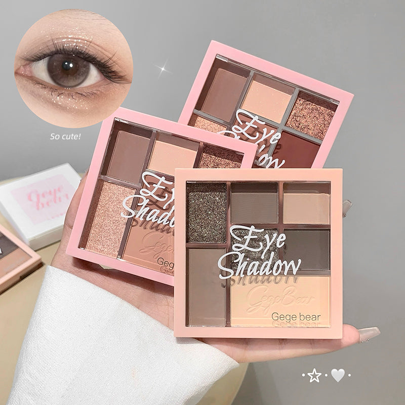 Three pink eye shadow palettes held in a hand with an eye wearing makeup close-up.