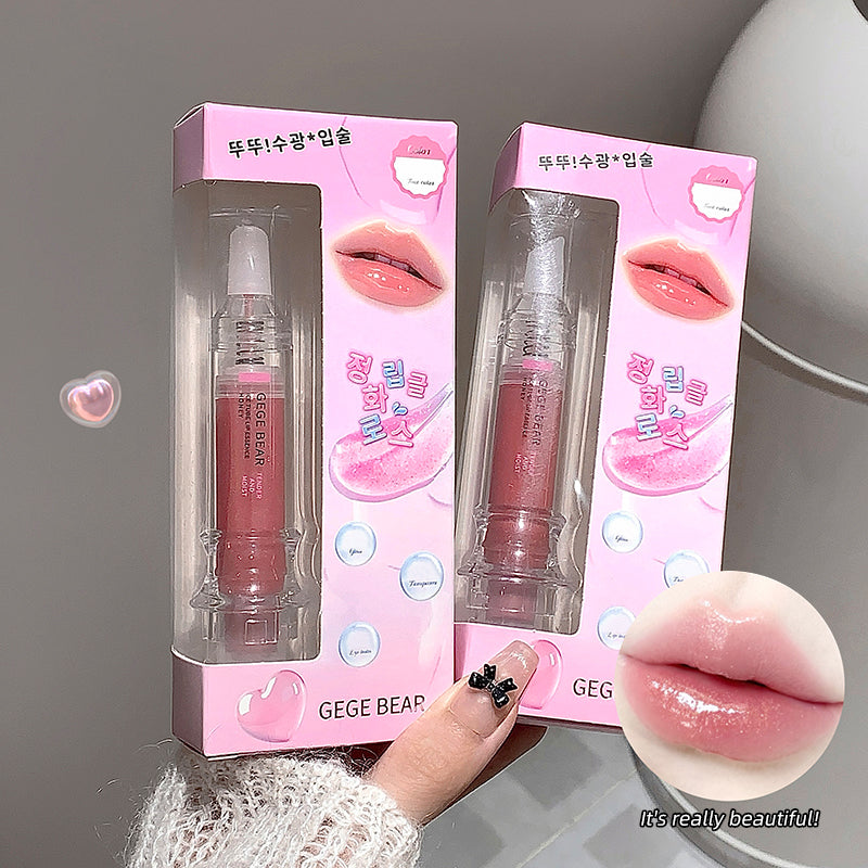 Two pink lip gloss packages with a hand holding one, showing a close-up of lips with gloss.