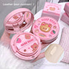 Pink bear cushion with open case on a white surface