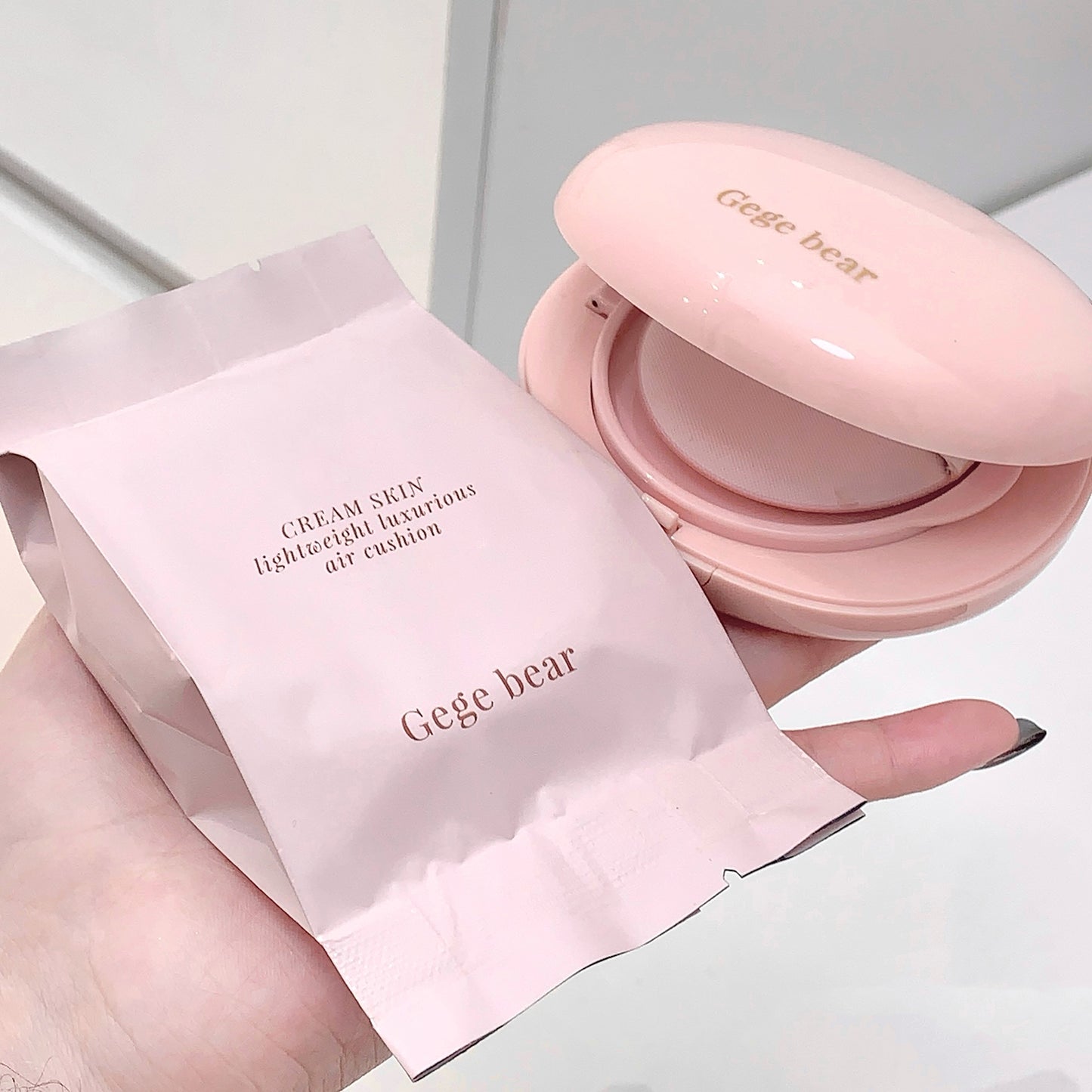 Pink Gege bear air cushion compact and packaging on a light background
