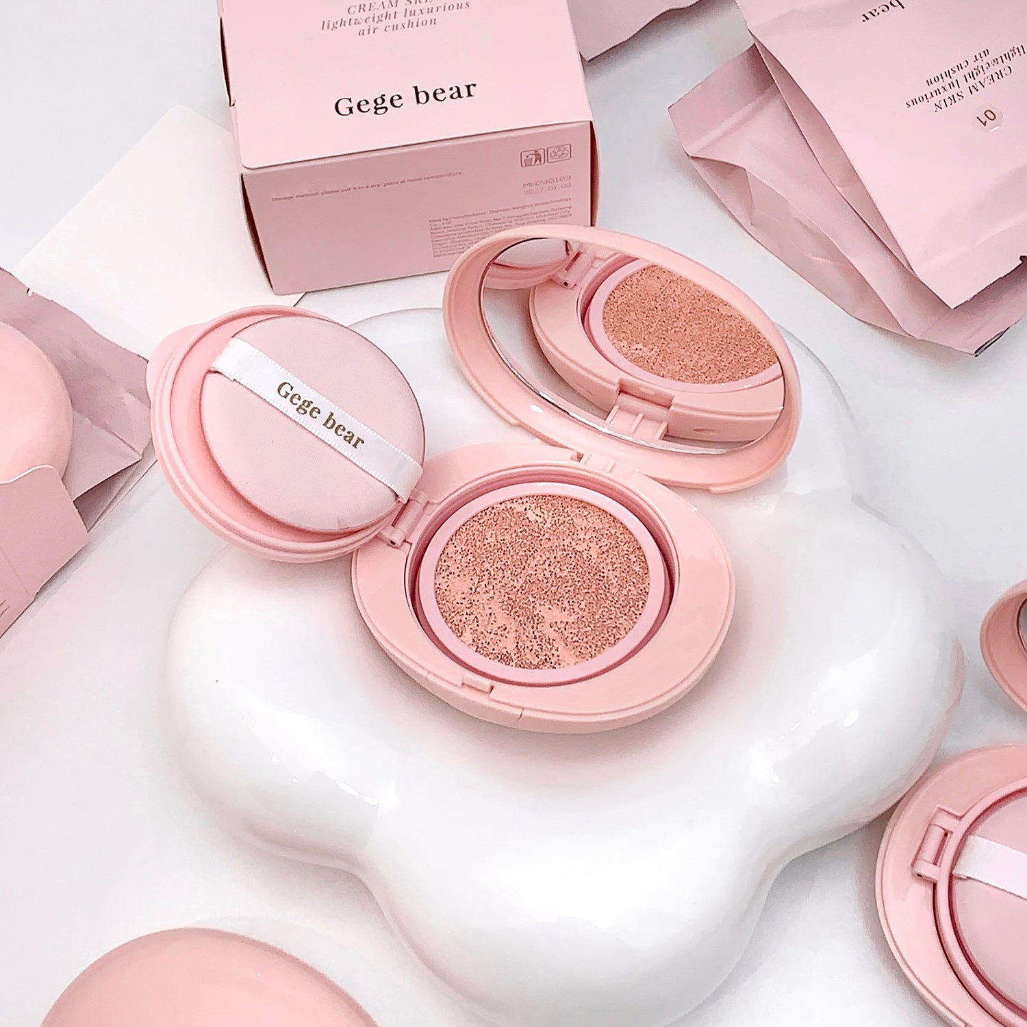 Pink makeup compact with 'Gege bear' branding on a white surface.