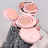 Pink cosmetic compact with two shades held by a hand against a neutral background