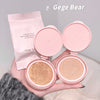 Two pink makeup cushions with open covers held by a hand, branded 'Gege Bear'.