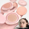 Pink makeup compact with a mirror and a sample of the product on a white background.