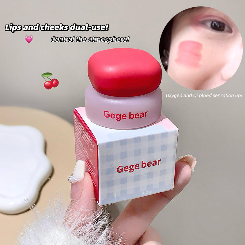 Gege bear lip and cheek product with packaging held by a hand, close-up of application on face.