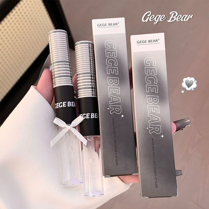 Two GEGE BEAR hairbrushes and their packaging held by a hand.