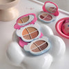 Makeup palettes with pink and white cases on a white surface