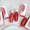 Red lip gloss bottles with white caps and 'Gege bear' packaging on a light background