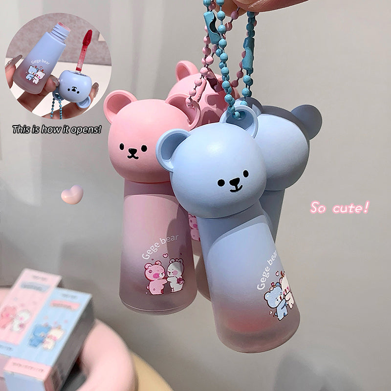 Two bear-shaped water bottles with keychains on a plain background