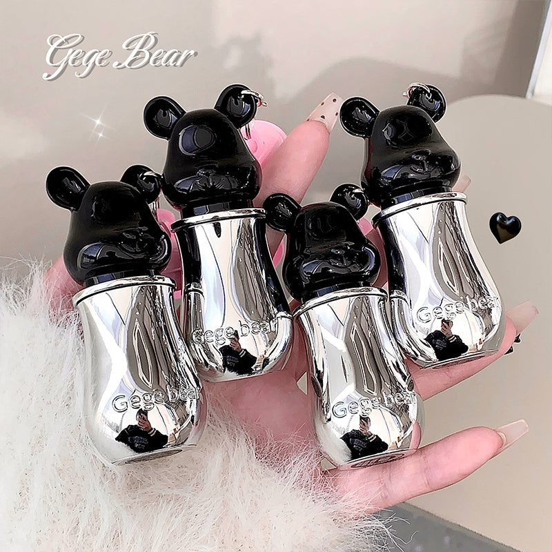 Silver bear-shaped bottle cases held in a hand with 'Gee Bear' branding.