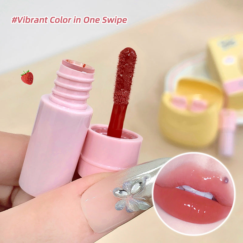 Pink lip gloss with applicator on a beige background